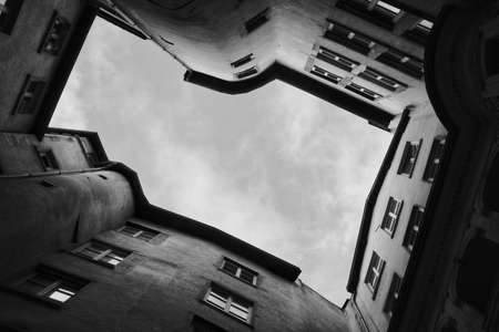 Beautiful architecture and white sky shot from below in black and whiteの写真素材
