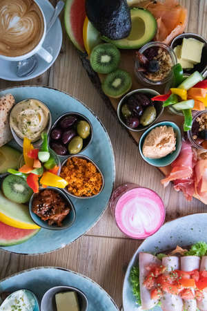 A vertical high angle shot of traditional Ethiopian food with fruits and vegetables on a tableの写真素材