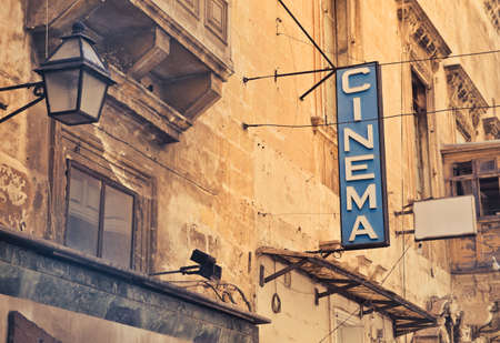 A shot of cinema sign on a brown buildingの写真素材
