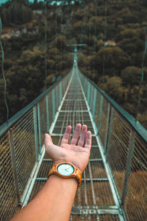 POV shot of a hand on a bridgeの写真素材