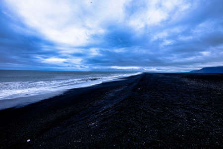 A beautiful shot of a sea near the shore under a cloudy skyの写真素材