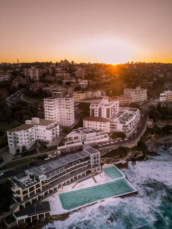 Beautiful aerial shot of a coastal city and the sea at dawnの写真素材