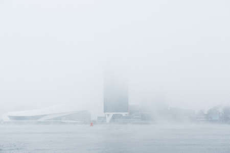 A mysterious building in the snowy white fogの写真素材