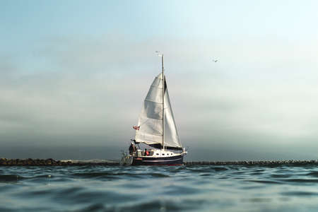 A shot of a sailboat on the body of water under a clear skyの写真素材