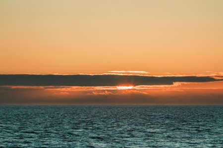 A beautiful scenery of the sunset sky over a peaceful sea