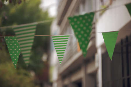 A closeup of green small flags with white dots and stripes on St. Patrick's Dayの写真素材