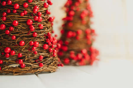 Miniature Christmas decorations with red dots and a white background