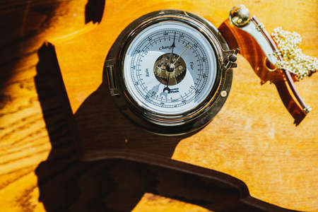 A closeup shot of a Compass on a yellow surfaceの写真素材