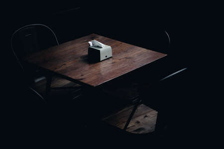 Napkins on a table in a dark cafe roomの写真素材