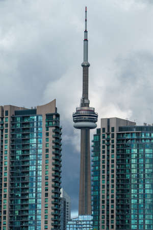 A vertical aerial shot of CN Tower in Toronto under cloudy skyのeditorial素材