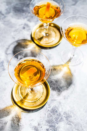 A vertical high angle shot of champagne glasses with reflections on the marble surfaceの写真素材