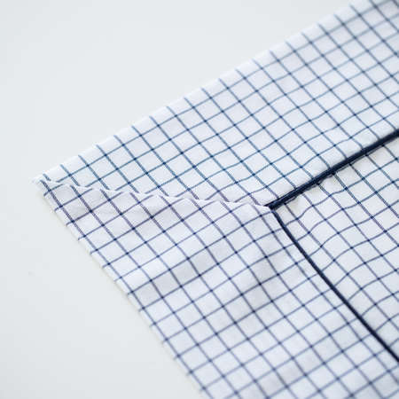 A closeup shot of a tablecloth with black and white patterns