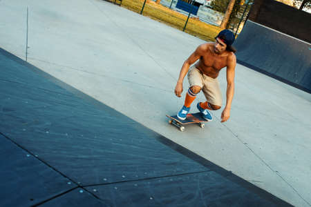 A young Caucasian man skateboarding in the parkの写真素材