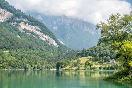 A beautiful view of the calm lake of Tenno, located in Trentino, Italy during daylight
