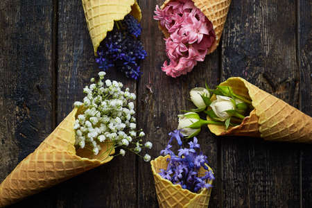 waffles for ice cream with flowers on a black backgroundの写真素材