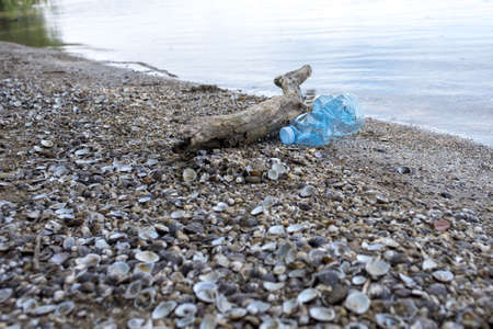 A rocky beach with plastic pollution - environmental pollution conceptの写真素材