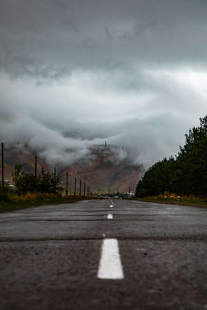 Beautiful shot of a road going toward foggy mountains