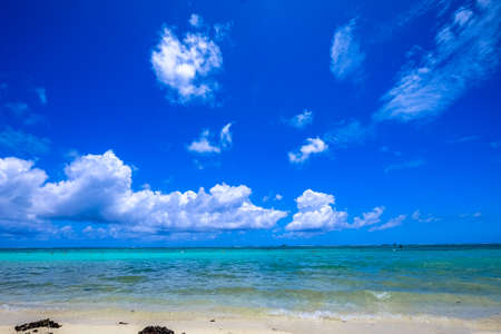 A beautiful shot of a beach with clouds in the blue sky on a sunny day