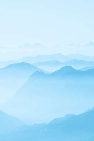 Beautiful shot of high white hilltops and mountains covered in fog - amazing aesthetic natural backgroundsの写真素材