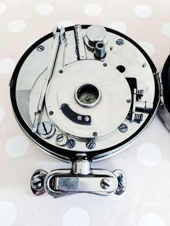 A closeup shot of a pocket phonograph on a light dotted background