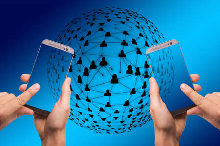 A closeup view of hands holding phones with a connection network on the blue background