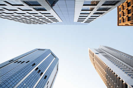 A bottom view of the modern skyscrapers against the blue sky in Sydney, Australiaの写真素材