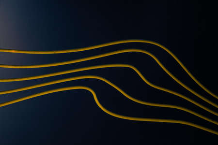 Curved yellow pipe lines on dark blue background