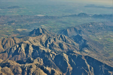 An aerial shot of Sneeuberg Mountains and grassy fields in the distance