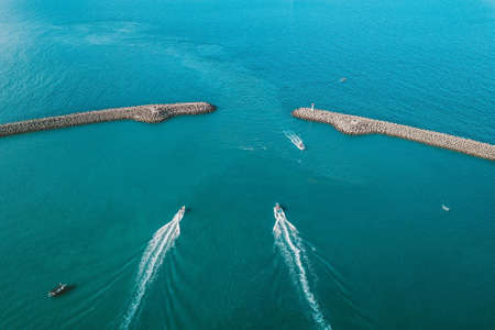 An aerial view of white boats sailing in the peaceful seaの写真素材