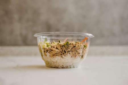 A closeup shot of a clear plastic bowl with food insideの写真素材