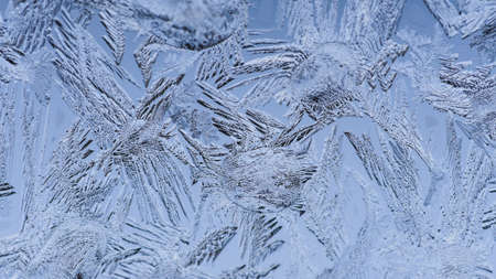 A closeup shot of beautiful frost patterns and textures on a glass