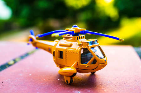 Yellow toy helicopter in soft focus backgroundの写真素材