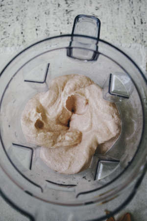 An overhead closeup shot of a spinning blender with fruit in it