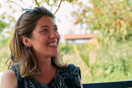 A portrait of a young smiling Hispanic female at daytime
