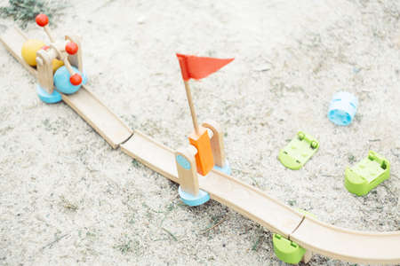 An overhead shot of wooden road toys with balls on the groundの写真素材