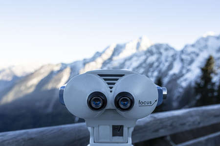 A selective focus closeup shot of white coin operated binoculars