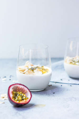 A vertical shot of coconut and passion fruit drink on a white surface