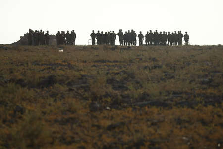 A distant shot of a lot of soldiers standing on the top of the hill in Armenia