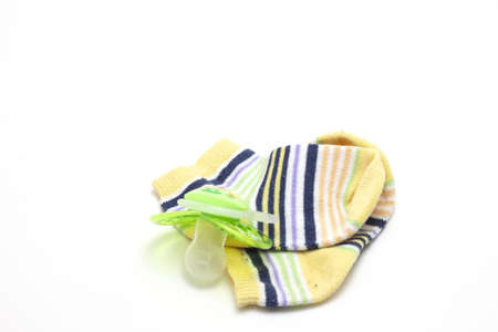 A closeup shot of the baby socks and pacifier isolated on white background