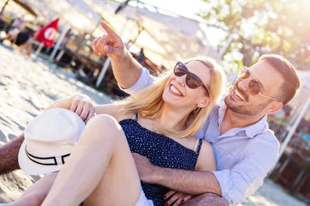 A closeup shot of a happy caucasian couple on the beachの写真素材