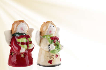 A closeup shot of two little angel statues isolated on a white background