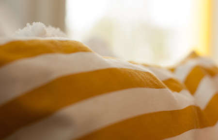 An extreme closeup of yellow and white pillowcaseの写真素材