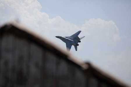 A selective focus shot of an aircraft flying high above the sky