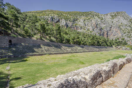 The image shows the ancient stadium at Delphi which was built on the highest point in the town and...