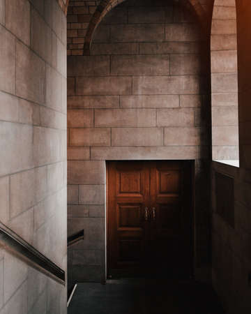 A beautiful interior shot of a brown door in a stone buildingの写真素材