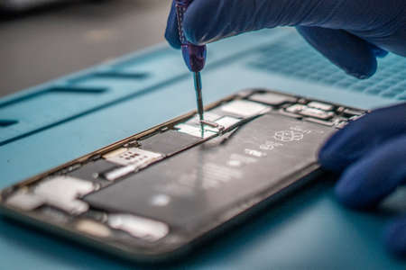A closeup shot of a specialist repairing a mobile phoneの写真素材