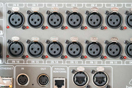 A closeup selective focus shot of professional studio audio recording equipment with a microphone...