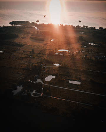 A beautiful green open field during sunrise in the countrysideの写真素材