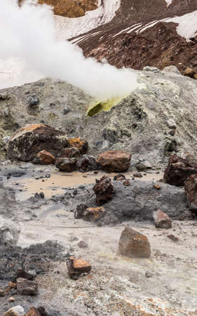 A vertical picture of mineral rocks and Mutnovsky Volcano in Kamchatka, Russia