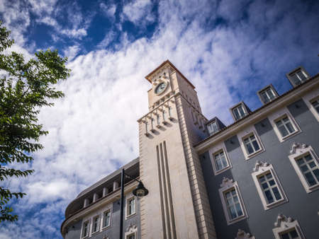 A low angle shot of a building and a tower in Lisbon, Portugal
